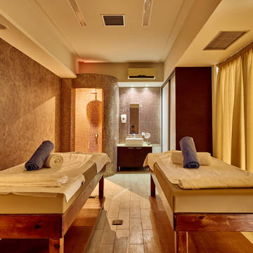 Paralos Kosta Alimia Spa room with two massage beds, decorations and amenities