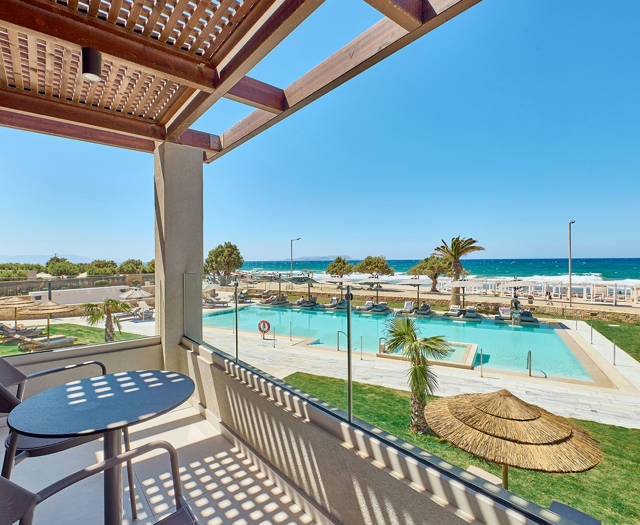 Paralos Kosta Alimia Double Room Direct Sea View balcony with a round table, a pair of chairs and view of the pool and the sea