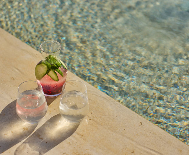 Paralos Kosta Alimia two glasses of water and a cocktail at poolside