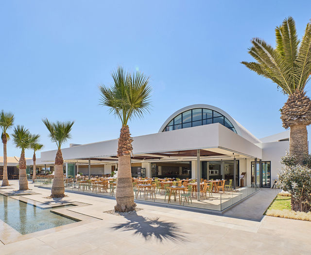 Paralos Kosta Alimia view of the restaurant outdoor sitting area with some palm trees