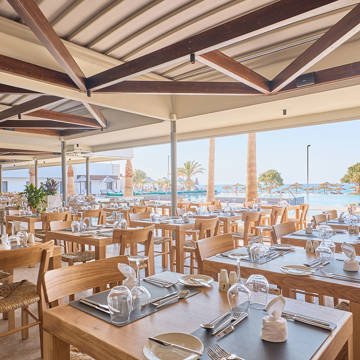 Paralos Kosta Alimia Greek Taverna sitting area with the pool in the background