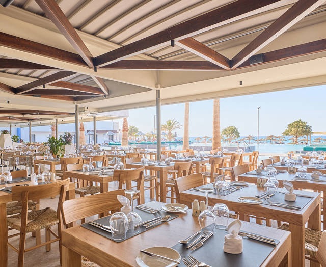 Paralos Kosta Alimia Greek Taverna sitting area with the pool in the background