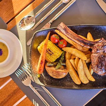 Paralos Kosta Alimia Steakhouse steak with french fries and vegetables