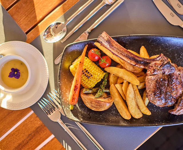 Paralos Kosta Alimia Steakhouse steak with french fries and vegetables