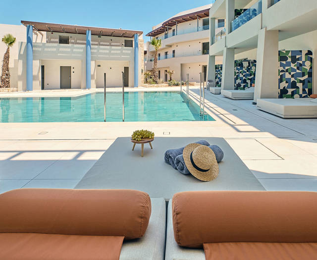 Paralos Kosta Alimia Junior Suite Swim Up terrace with decorated double sunbed and pool